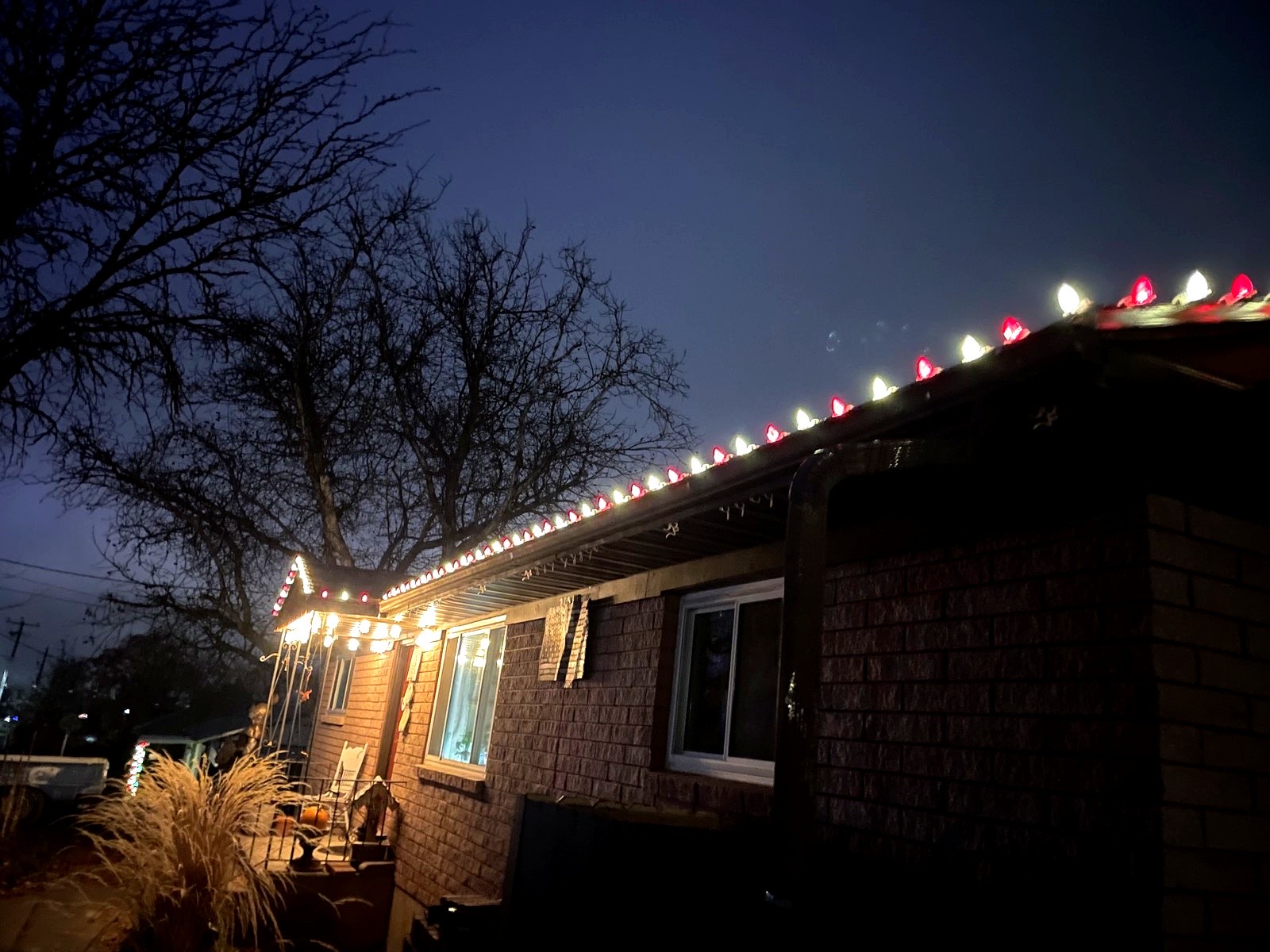 Close-up of red and white C9 bulbs along a roofline