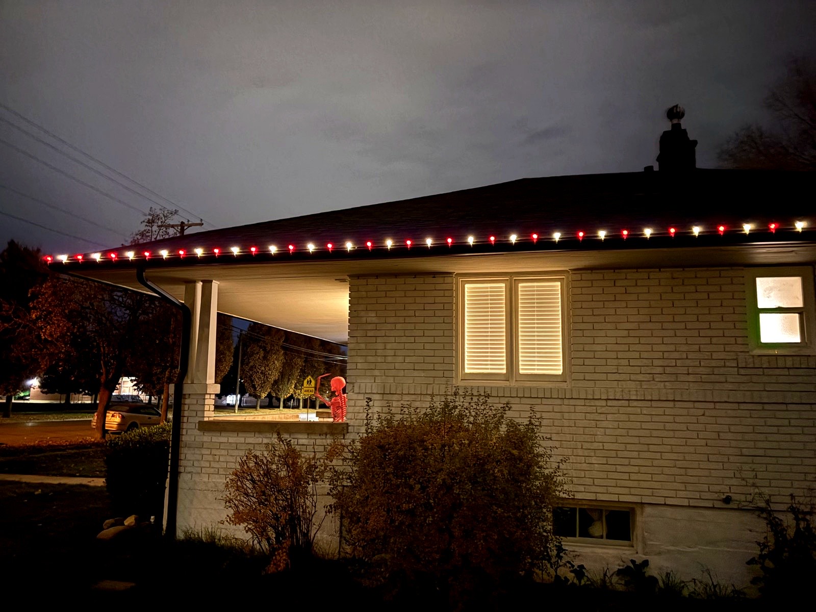 Single-story home with red and white roofline lighting